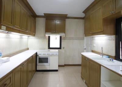 Spacious kitchen with wooden cabinetry and modern appliances