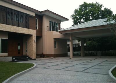 Exterior view of a modern house with driveway and carport