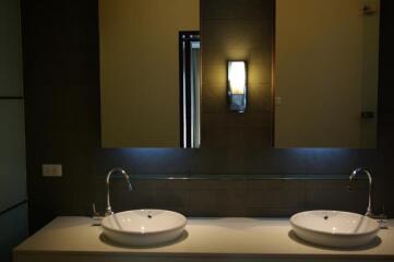 Modern bathroom with dual sinks and ambient lighting