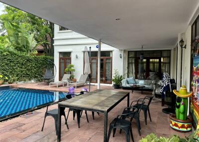 Outdoor patio with dining table near swimming pool