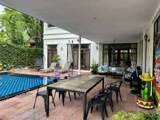 Outdoor patio with dining table near swimming pool