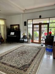 Spacious and well-lit living room with a large window and decor