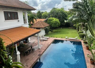 Outdoor view of backyard with pool and garden