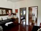 Living area with piano and view to bedroom