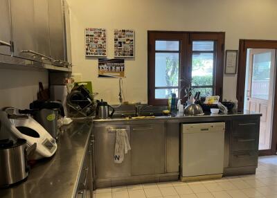 Modern kitchen with stainless steel appliances and large windows