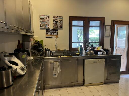 Modern kitchen with stainless steel appliances and large windows