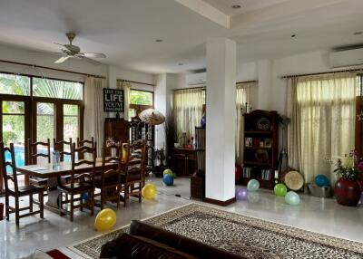 Spacious living room with dining area and natural light