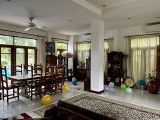 Spacious living room with dining area and natural light