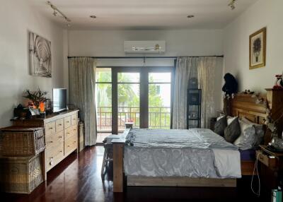 Spacious bedroom with large windows and balcony access