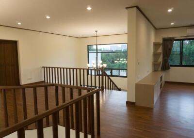 Spacious living area with wooden flooring and large windows