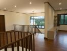 Spacious living area with wooden flooring and large windows