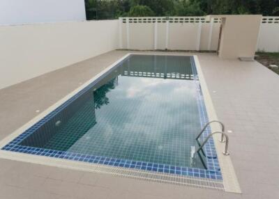 Outdoor swimming pool with tiled deck