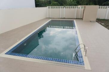 Outdoor swimming pool with tiled deck