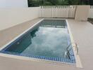 Outdoor swimming pool with tiled deck