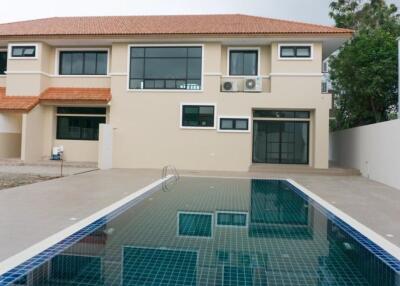 Backyard with swimming pool and modern two-story house