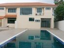 Backyard with swimming pool and modern two-story house