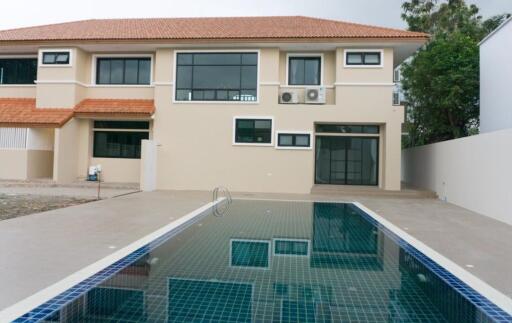 Backyard with swimming pool and modern two-story house