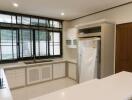 Modern kitchen with large window and ample storage