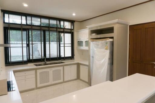 Modern kitchen with large window and ample storage