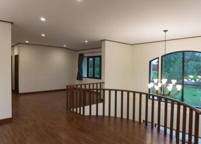 Spacious main living area with wooden flooring and large windows