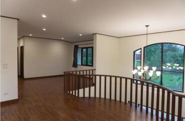 Spacious main living area with wooden flooring and large windows