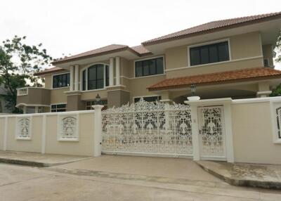 Modern two-story house with ornate white fence