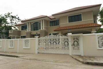 Modern two-story house with ornate white fence