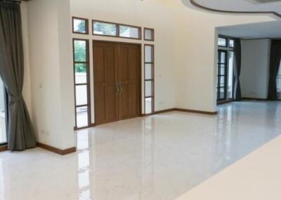 Spacious living room with high ceilings and large windows