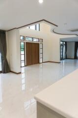 Spacious living room with high ceilings and large windows