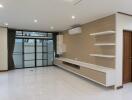 Spacious living room with large windows and built-in shelving