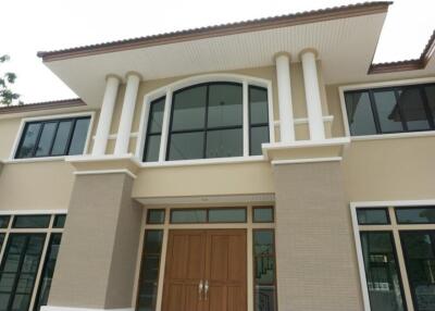 Facade of a modern two-story house with large windows