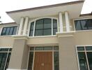 Facade of a modern two-story house with large windows