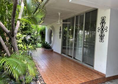 Outdoor patio area with tiled floor and plants