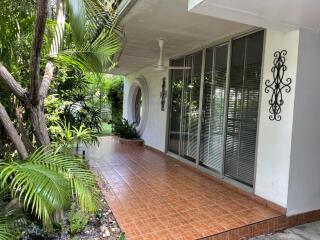 Outdoor patio area with tiled floor and plants