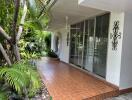 Outdoor patio area with tiled floor and plants