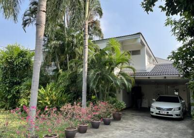 Main house exterior with garden and driveway