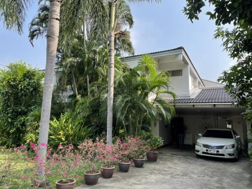 Main house exterior with garden and driveway