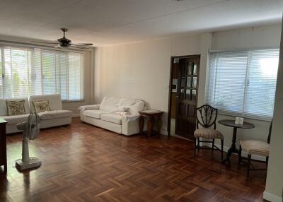 Spacious living room with wooden flooring and furniture