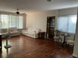 Spacious living room with wooden flooring and furniture