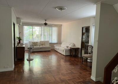 Spacious living room with wooden floor and large windows