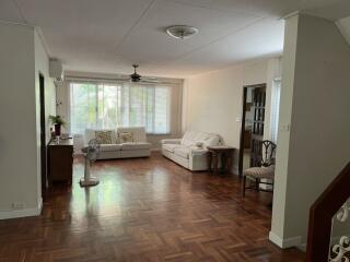 Spacious living room with wooden floor and large windows