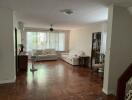 Spacious living room with wooden floor and large windows