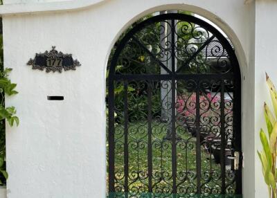 Decorative metal gate with house number