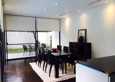 Modern dining room with dark furniture and a large window