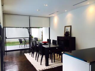 Modern dining room with dark furniture and a large window