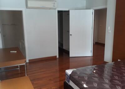 Bedroom with wooden flooring and air conditioning