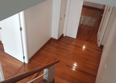 A view of the hallway with wooden flooring and open doors