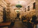 Rustic stone-walled room with arched ceiling