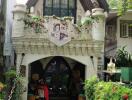 Front view of a decorative house with flowered balcony and plush bears