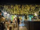 Cozy restaurant interior with hanging lights and patrons